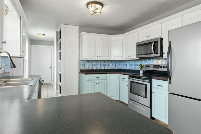 kitchen featuring sink, white cabinetry, appliances with stainless steel finishes, and tasteful backsplash