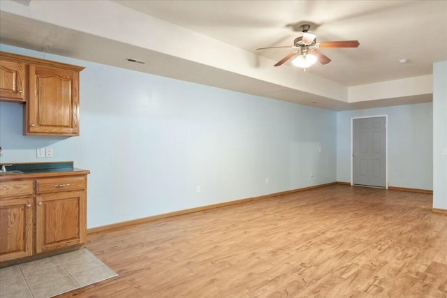 interior space featuring light hardwood / wood-style floors, sink, and ceiling fan