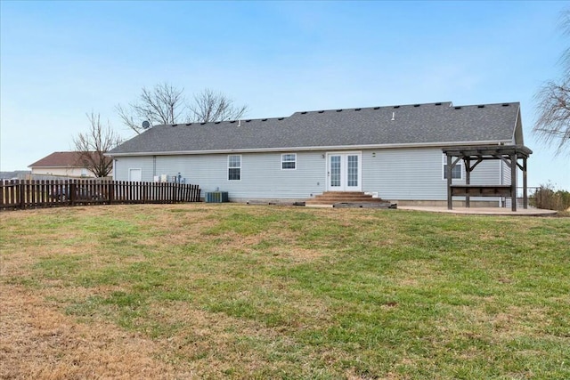 rear view of property featuring central AC unit, a pergola, a patio area, and a yard