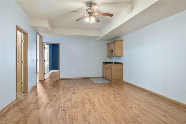 unfurnished living room with ceiling fan and light hardwood / wood-style flooring