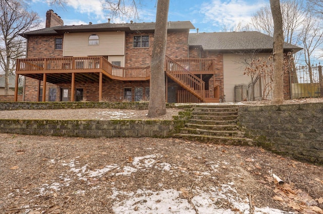 snow covered property featuring a patio area and a wooden deck