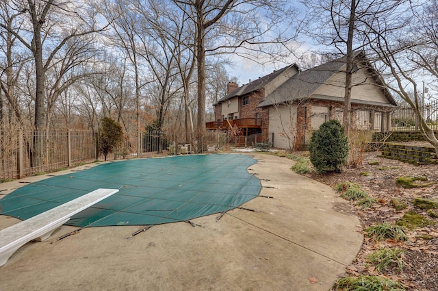 view of pool featuring a diving board