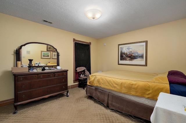 carpeted bedroom with a textured ceiling