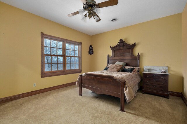 bedroom with light carpet and ceiling fan