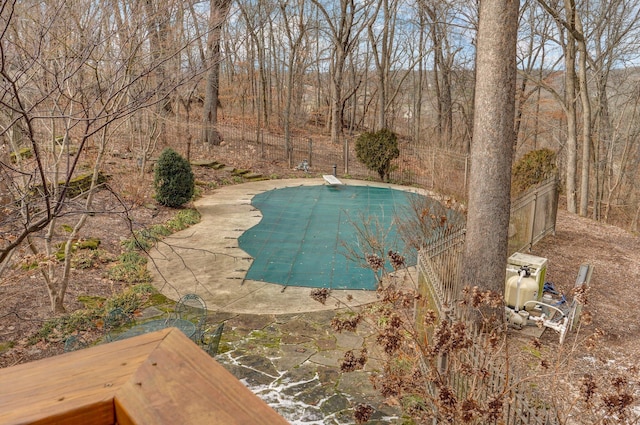 view of swimming pool featuring a diving board and a patio area