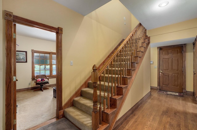 stairs featuring wood-type flooring