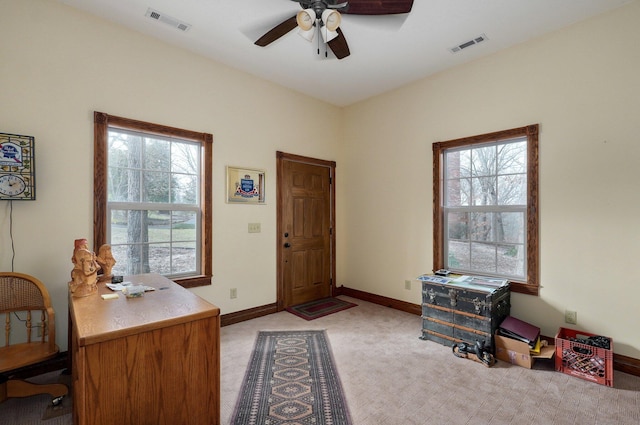 interior space featuring light carpet and ceiling fan