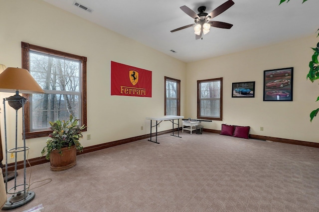 interior space with ceiling fan and carpet