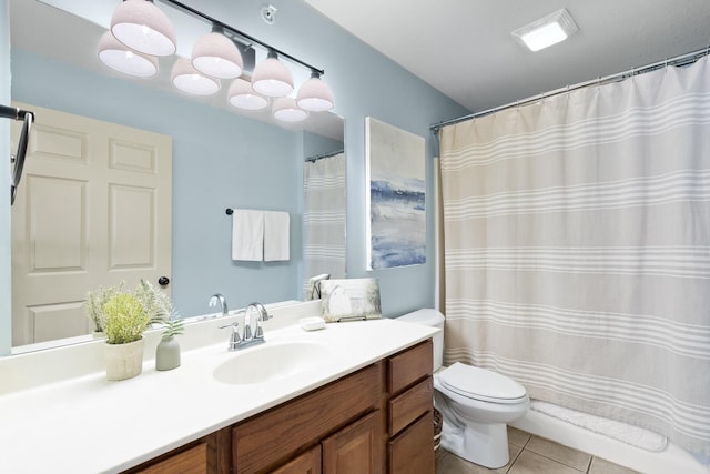 bathroom with toilet, tile patterned floors, and vanity