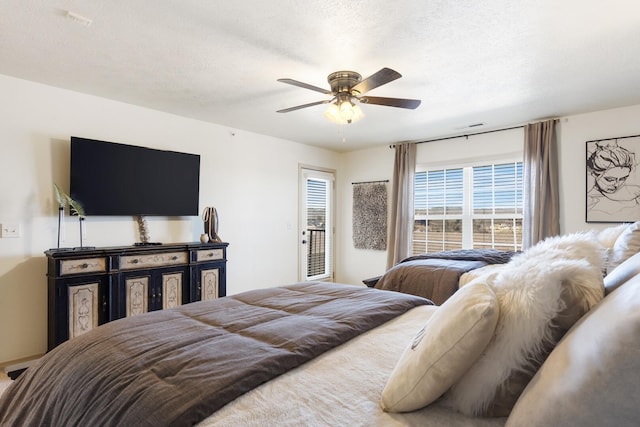 bedroom featuring a textured ceiling and ceiling fan