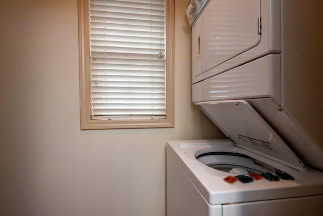 laundry area featuring stacked washer and clothes dryer