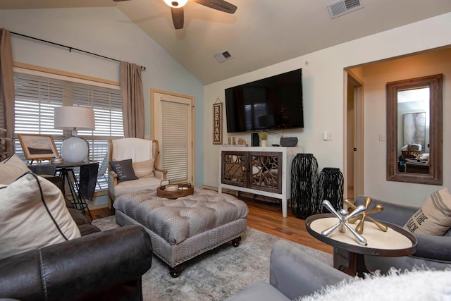 living room featuring ceiling fan, wood-type flooring, and lofted ceiling