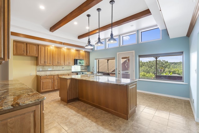 kitchen with range, light tile patterned flooring, light stone countertops, pendant lighting, and a center island