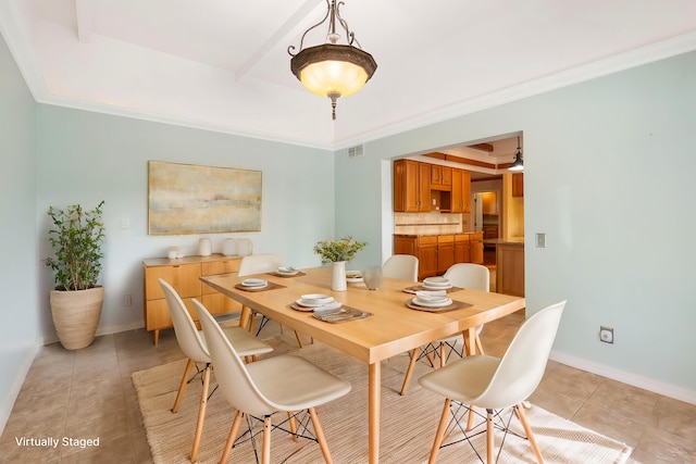 dining space featuring light tile patterned floors, crown molding, and a tray ceiling