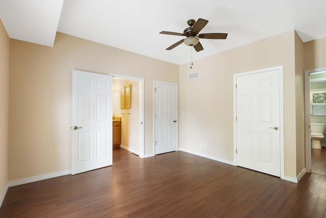 unfurnished bedroom with ceiling fan, connected bathroom, and dark hardwood / wood-style floors