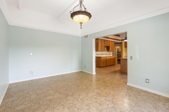 spare room featuring a raised ceiling and crown molding