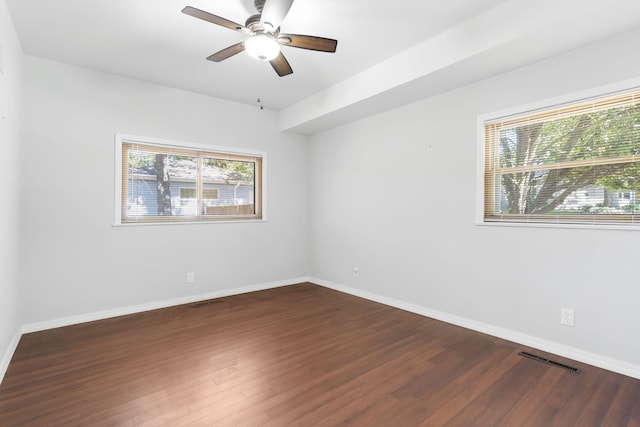 empty room with ceiling fan and dark hardwood / wood-style floors