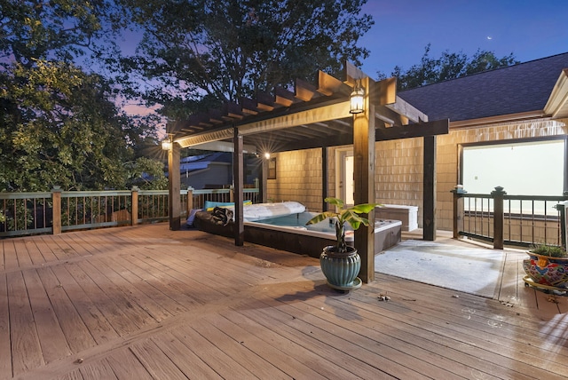 deck at dusk featuring a jacuzzi and a pergola