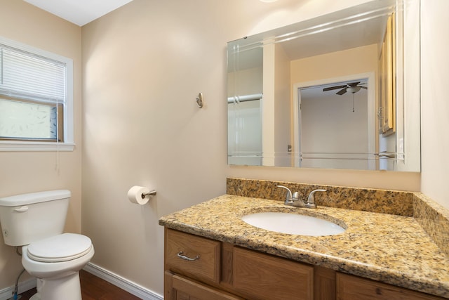 bathroom with ceiling fan, vanity, and toilet