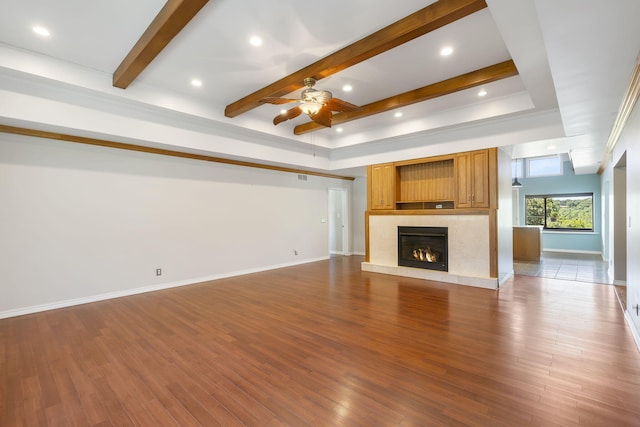 unfurnished living room featuring ceiling fan, wood-type flooring, and a premium fireplace