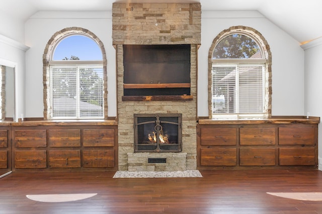 unfurnished living room with vaulted ceiling, a fireplace, and dark hardwood / wood-style floors