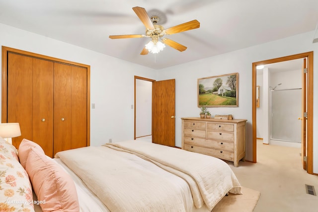 carpeted bedroom featuring ceiling fan and a closet