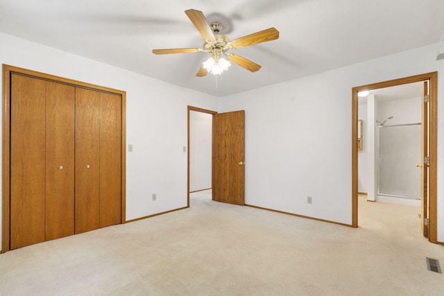 unfurnished bedroom featuring ceiling fan, light carpet, and a closet