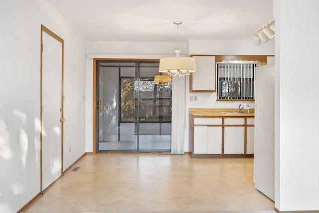 interior space featuring sink and a chandelier