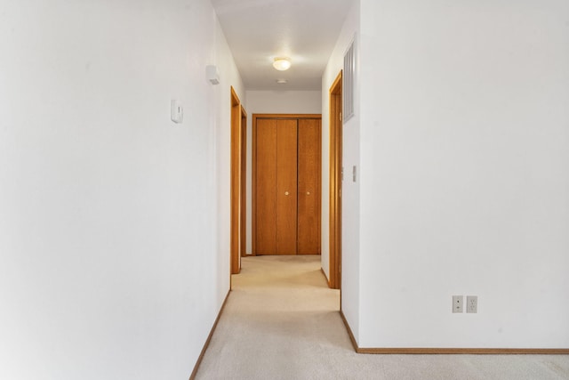 hallway featuring light carpet