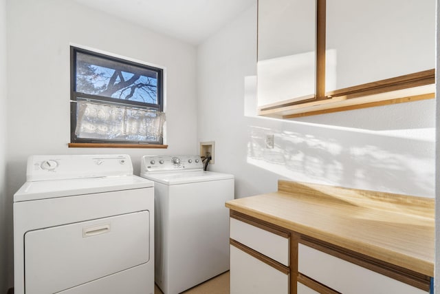 washroom with cabinets and separate washer and dryer