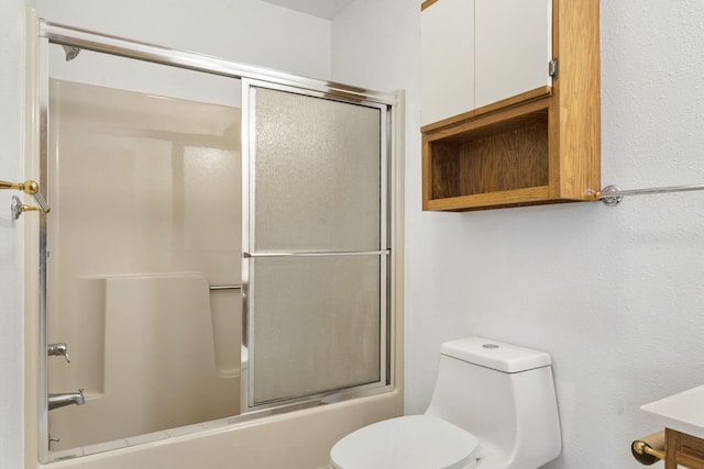 full bathroom featuring toilet, enclosed tub / shower combo, and vanity