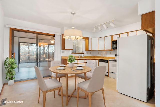 dining room with an inviting chandelier and sink