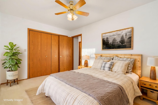 bedroom featuring ceiling fan, light colored carpet, and a closet