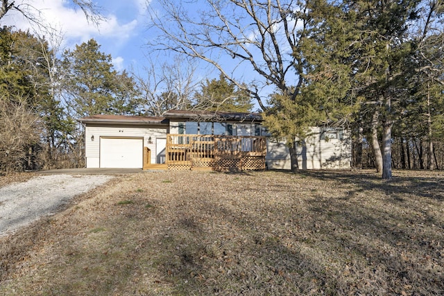 view of front of house with a wooden deck and a garage