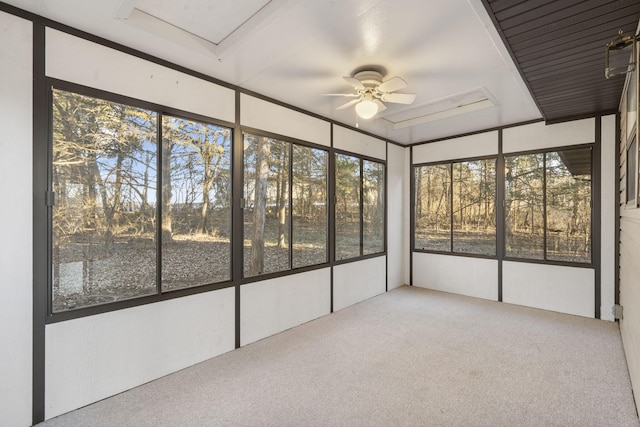 unfurnished sunroom featuring ceiling fan