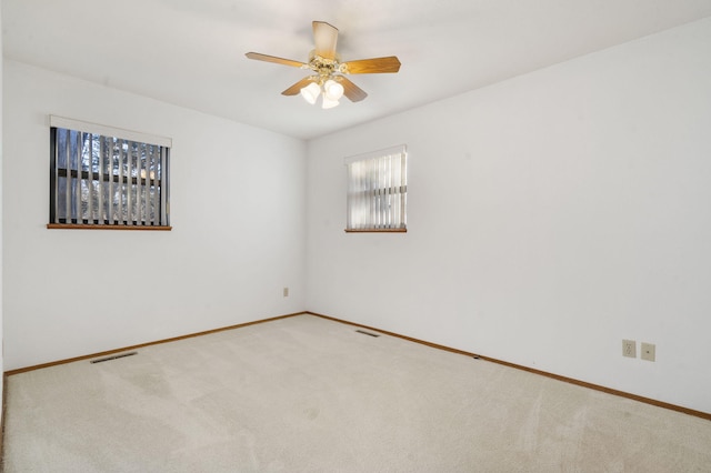 unfurnished room with ceiling fan and carpet floors