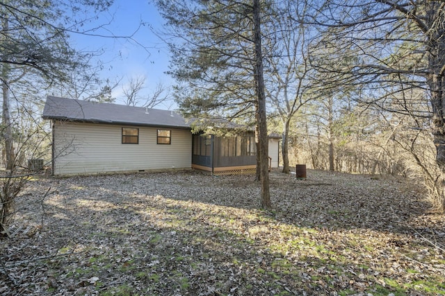 rear view of property featuring a sunroom