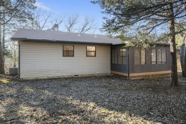 back of property with a sunroom and central air condition unit