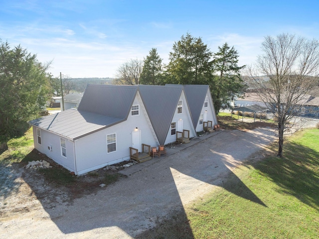 view of home's exterior featuring a lawn and a carport