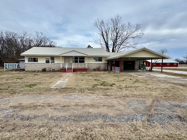 ranch-style home with a porch and a carport