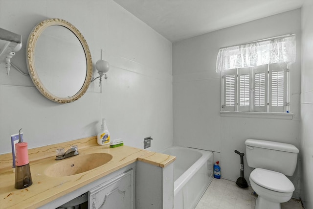 bathroom featuring toilet, vanity, and a tub