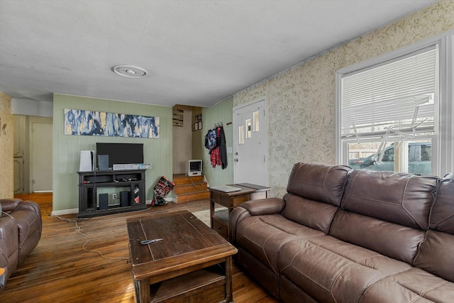 living room with wood-type flooring and a wall unit AC