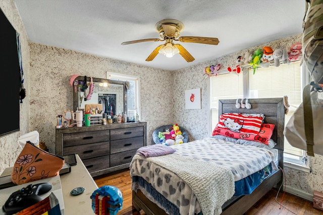 bedroom featuring ceiling fan and dark hardwood / wood-style flooring