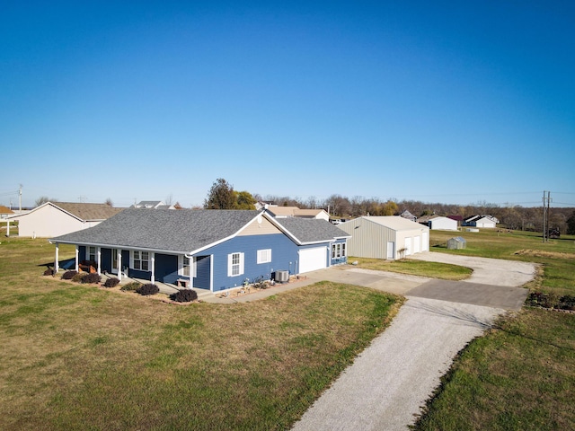 view of front of home with a front yard and central AC unit