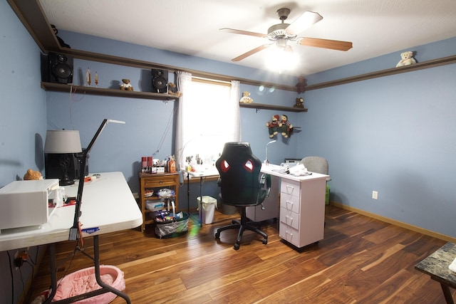 home office with ceiling fan and dark hardwood / wood-style floors