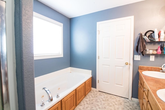 bathroom with a bath and vanity