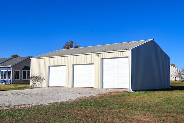 garage featuring a lawn