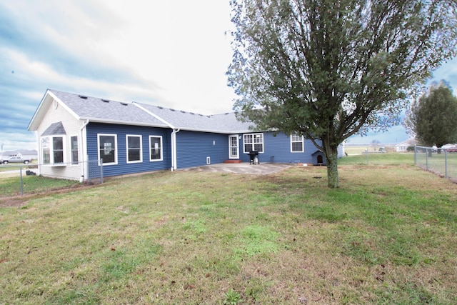 back of house featuring a yard and a patio