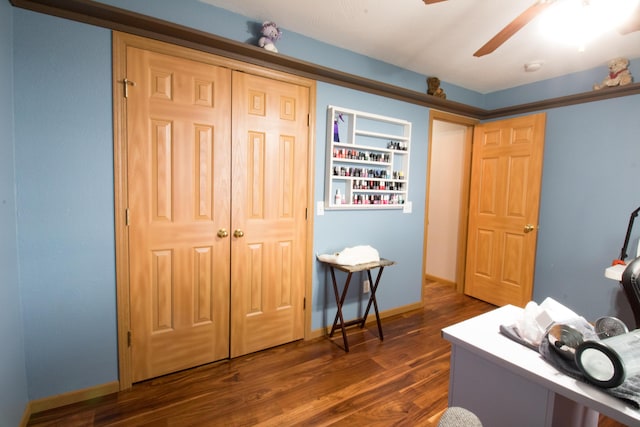 office area with ceiling fan, built in features, and dark hardwood / wood-style flooring