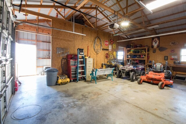 garage with a workshop area and a garage door opener